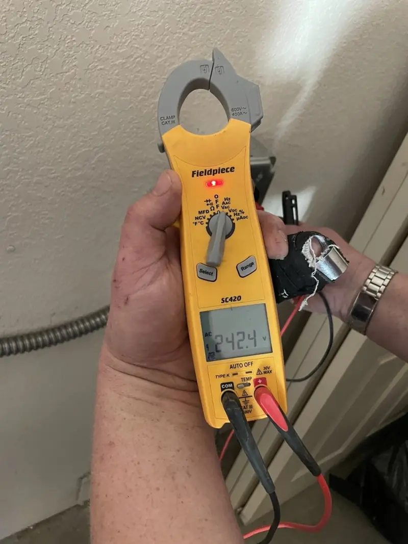 Voltage testing with clamp meter during Outlet Installation in Safford